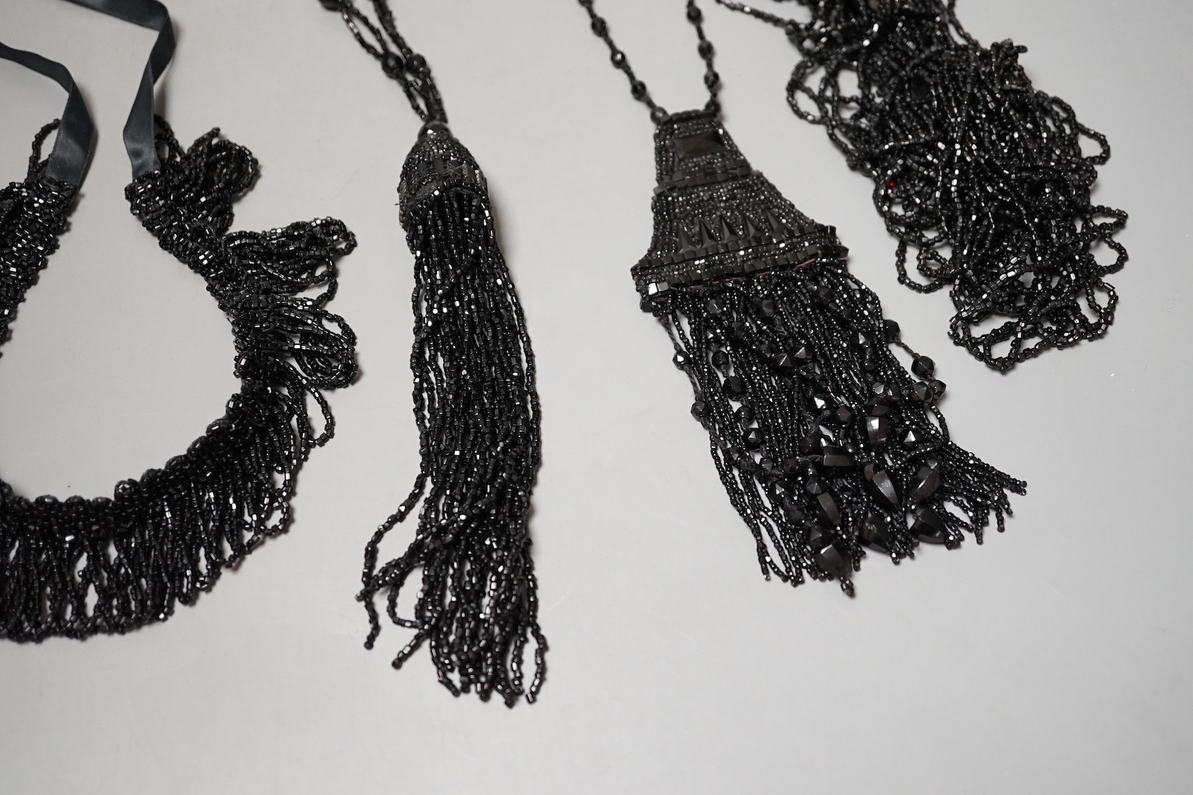 Four assorted French jet necklaces, largest approx. 104cm.